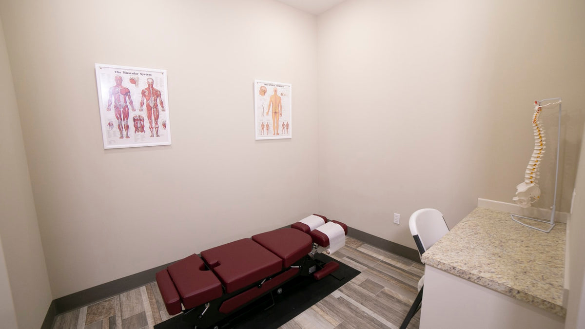 Chiropractic treatment table with headrest inside a clinic