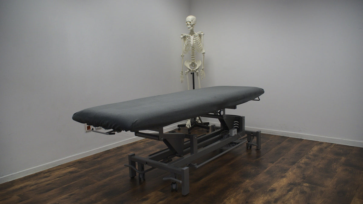 Chiropractic treatment table frame in a clinic treatment room